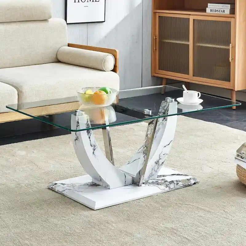 Moderner minimalistischer Couchtisch aus transparentem Hartglas mit MDF-Beinen in Marmoroptik und dekorativen Säulen aus Edelstahl