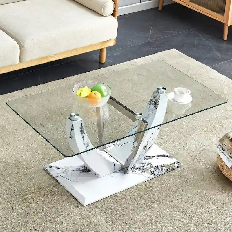 Moderner minimalistischer Couchtisch aus transparentem Hartglas mit MDF-Beinen in Marmoroptik und dekorativen Säulen aus Edelstahl
